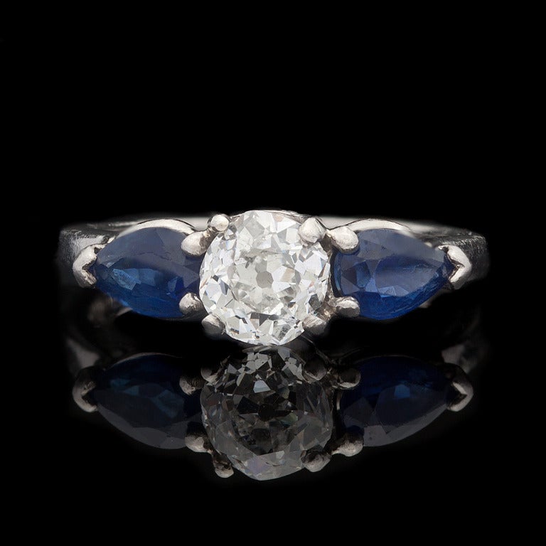 Vintage ring features one 0.77ct Old Mine Cut Diamond with 2 Pear Shaped Sapphires with a total approximate weight of 0.50cts in a platinum & 18Kt White Gold setting.  The total weight of the ring is 4 grams and a size 6.25.