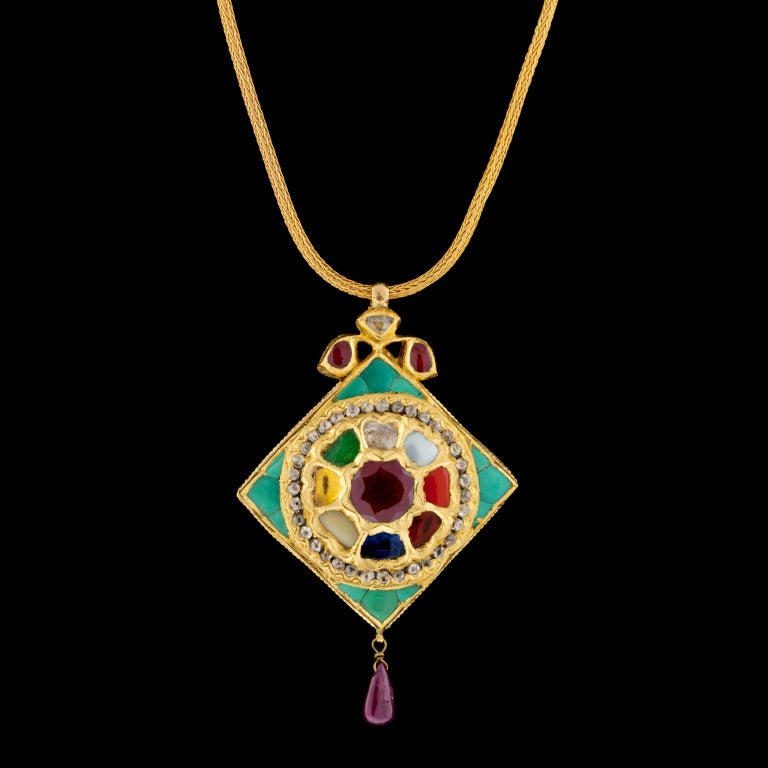 Vintage 20Kt Yellow Gold Diamond & Colored Stone Necklace features 36 Rose Cut Diamonds for a total approximate weight of 0.60cts & miscellaneous precious and semi precious colored stones with a 17″ chain. The pendant measures 2″ and the total