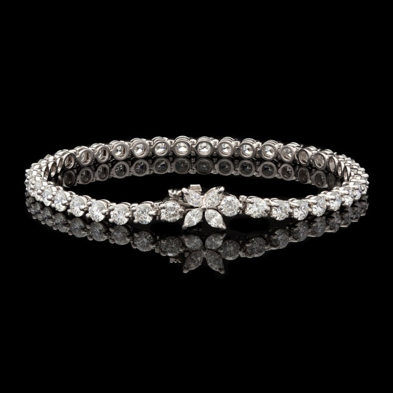 Tiffany & Co. Diamond Victoria Line Tennis Bracelet features 40 Round Brilliant Cut and 4 Marquise Cut Diamonds set in Platinum.  This piece weighs 15.5g and has a total carat weight of 5.90.  Bracelet measures 7″ long and is 3.5mm wide with a 7.5mm