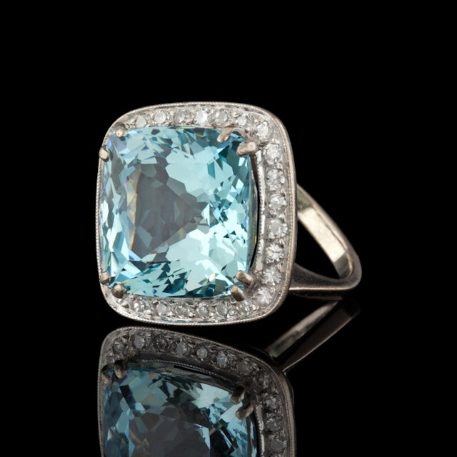 Estate 18KT White Gold Ring features a Square Cut Aquamarine for approximately 13.7cts, surrounded by 34 Round Cut Diamonds for a total approximate weight of 0.60cts.  Total weight of ring is 10.3 grams.