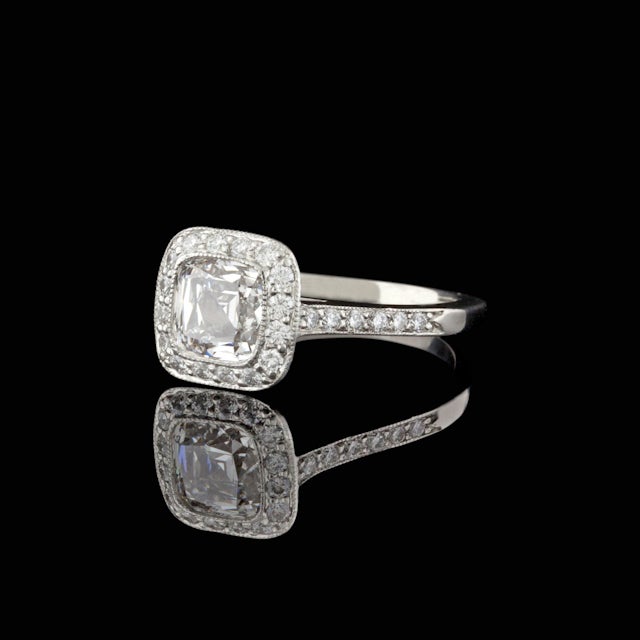 Tiffany & Co. Platinum Legacy Ring featuring one Cushion Cut Diamond for a total weight of 1.19cts, F color & VVS2 clarity, accented by 42 Round Cut diamonds for approximately 0.32cts, weighing 4.6 grams. Tiffany & Co. Diamond Certificate and Retail