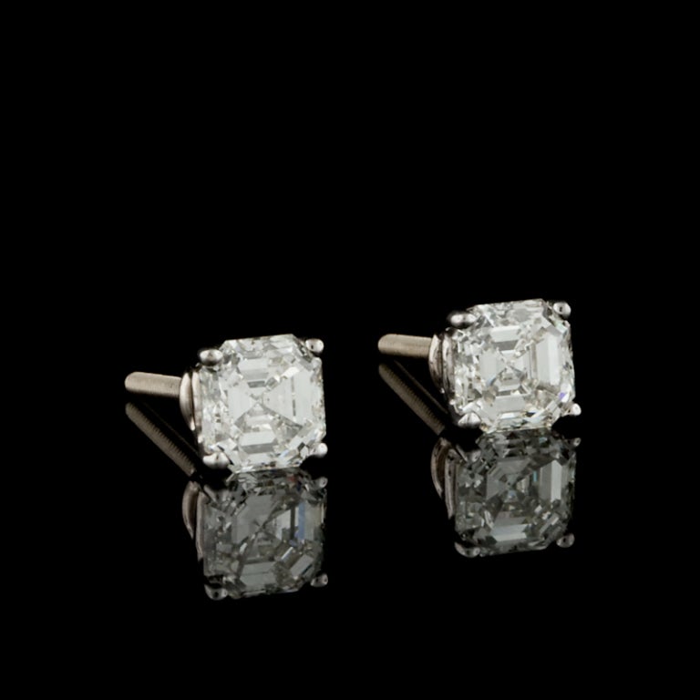 18KT White Gold Square Asscher Cut Diamond Stud Earrings for a total of 2.07cts. Diamonds are mounted in a four-pronged setting with screw posts and backs, weighing 1.90 grams.  K-L color, SI 1-2 clarity.
