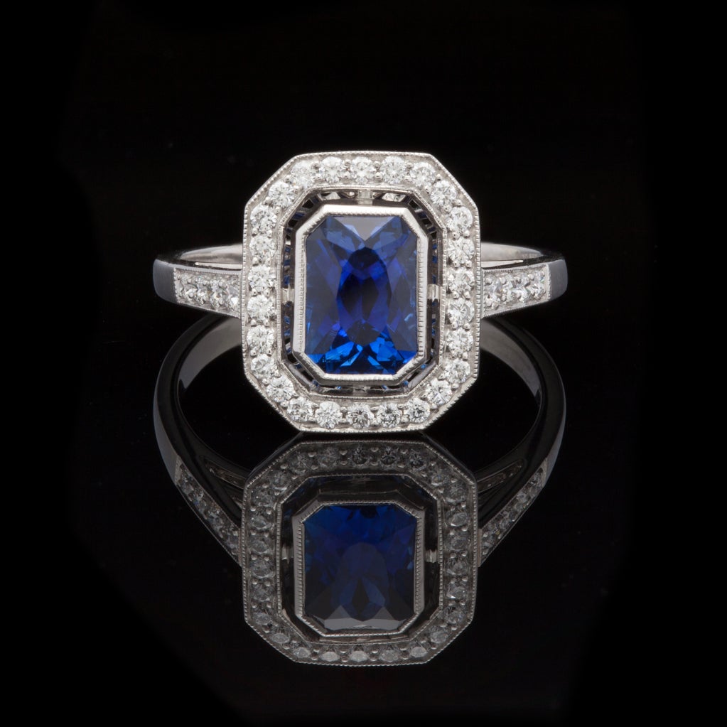 Platinum ring setting features one Octagonal Modified Brilliant Cut Natural Blue Sapphire for a total weight of 1.44cts accented by approximately 0.28cts of Round Brilliant Cut Diamonds.  The total weight of the ring is 5.1 grams and is a size 6.5.