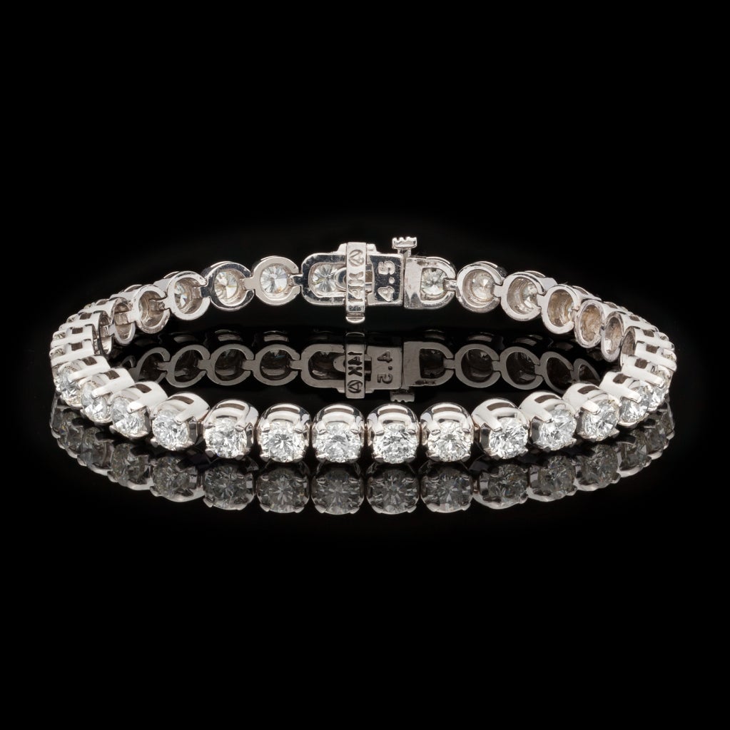 12.10ct tw Diamond Tennis Bracelet features 32 Round Brilliant Cut Diamonds set in 14Kt White Gold.  Bracelet measures 7