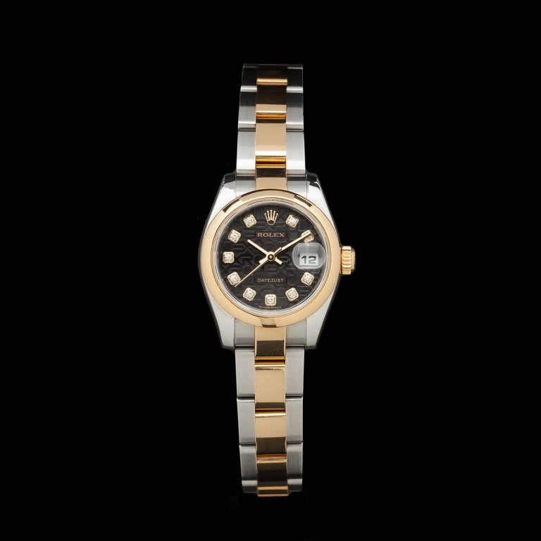 Rolex two-tone stainless steel and 18k yellow gold Lady Datejust wristwatch with black dial and diamond indexes. It has a 26mm case, and 6.25