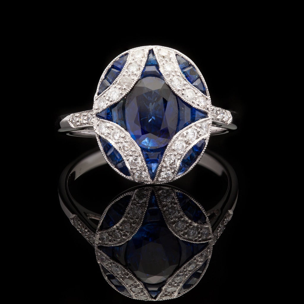 18Kt White Gold Ring with Mixed Cut Blue Sapphires for a total approximate weight of 1.98cts accented by 26 Round Brilliant Cut Diamonds with a weight of 0.36cts.  Ring is a size 7.25 and weighs 4.0 grams.