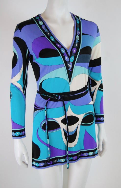 Emilio Pucci is one of history's most memorable designers. His name is synonymous with geometric prints in a kaleidoscope of colors.

This vintage dress features an abstract ovals print in aqua, violet, black and white. I has long sleeves, darts
