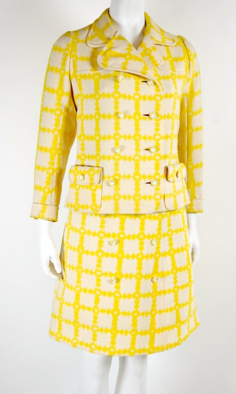 Emanuel Ungaro's fashion is bold, colorful, and exuberant. For forty years, his innovative designs have graced Paris runways.

Here's a vintage skirt suit featuring a yellow and cream checker print. Jacket has double-breasted styling with 8 rubber