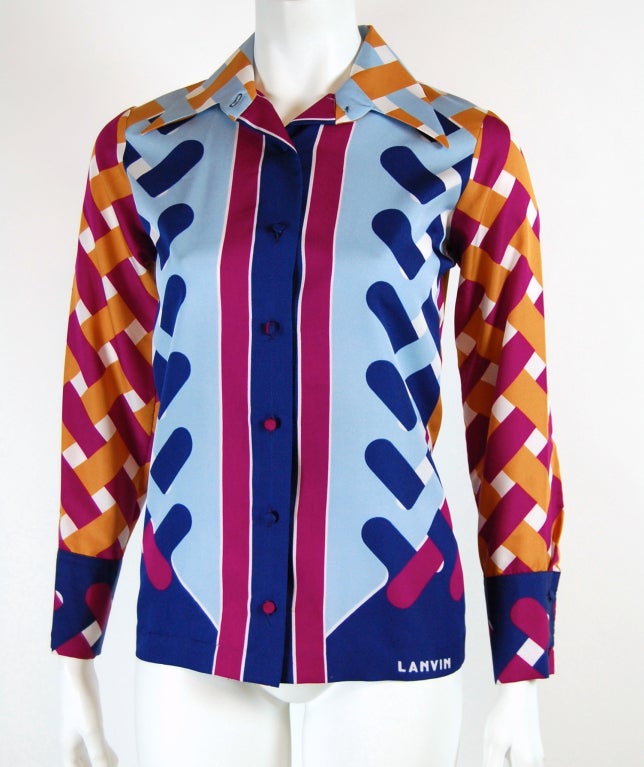 During the 1970's Lanvin produced a variety of boldly geometric printed garments and chunky pendant jewelry that is highly collectible today.

This vintage shirt features a jewel tone basket weave print in orange, magenta, blue and navy. It closes