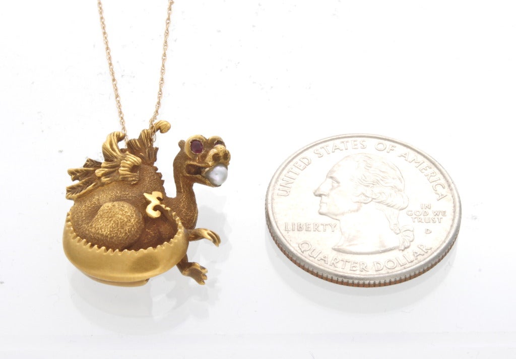 $1,250
This stunning, unusual Victorian era 14 karat yellow gold pendant features a three-dimensional dragon accented with a 2.9mm round cultured pearl in its mouth. Further accented with round faceted ruby eyes and complete with a 14kt yellow gold