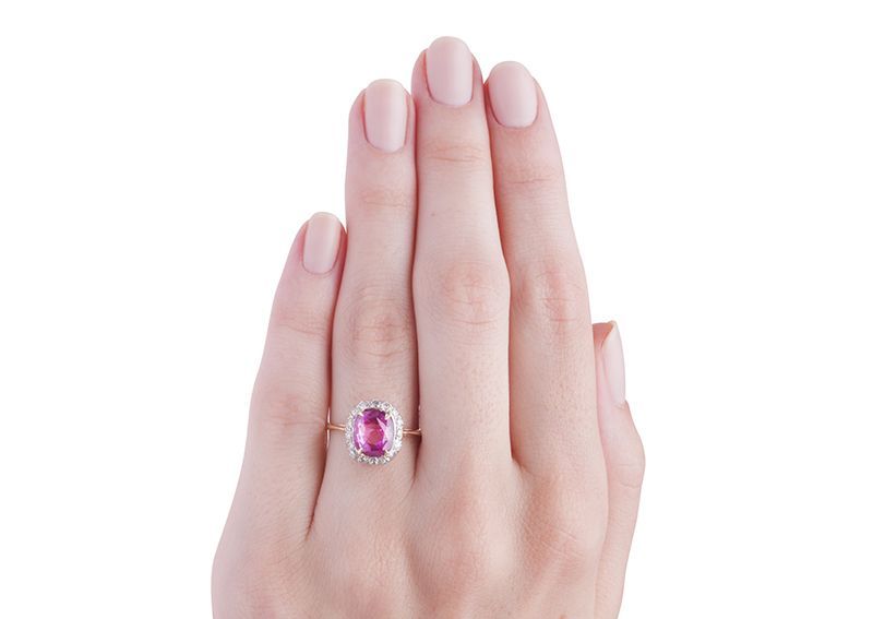 Magnolia is an amazing Edwardian ring made from 18k yellow gold and platinum featuring a 3.00ct GIA certified natural unheated pink sapphire. This gorgeous bright pink cushion cut sapphire is set with delicate claw prongs and is surrounded by a halo