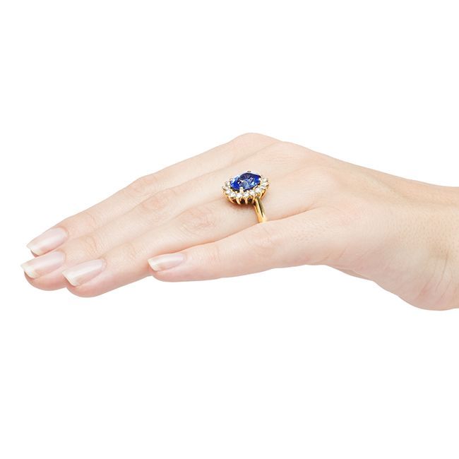 Creston is a decadent ring made from 18k yellow gold featuring a 4.17cts GIA certified natural oval cut sapphire. This bright blue sapphire is set in a glittering halo of sixteen Round Brilliant cut diamonds with a total approximate weight of 0.80ct