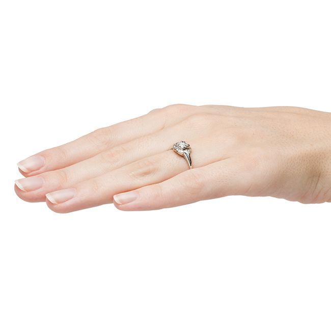 Island Falls is a simple yet elegant late Art Deco engagment ring set in platinum centering a 0.40ct EGL certified Old European cut diamond graded F color and VS1 clarity. This bright, clean stone is prong-set in a boxed setting further bordered by