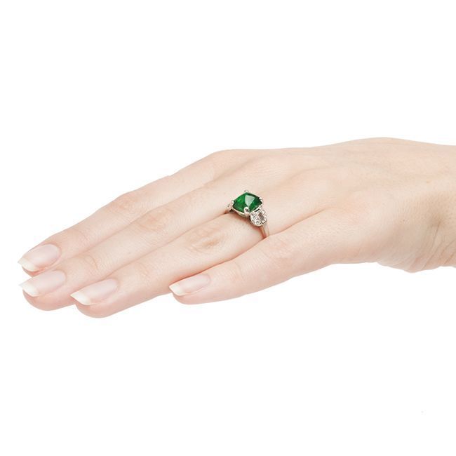 Indian Wells is a classic Art Deco emerald and diamond ring made from platinum featuring a bright green sugarloaf cabochon emerald weighing approximately 2.44cts accompanied with a Guild Laboratories Certificate stating this natural Colombian