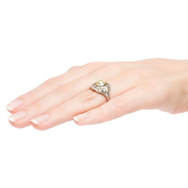 Sun Valley is a spectacular Art Deco ring made from platinum that features an impressive 1.77ct GIA certified Old European cut diamond with Natural Fancy Yellow color and VS1 clarity.  This gorgeous bright yellow diamond sits close to the finger in