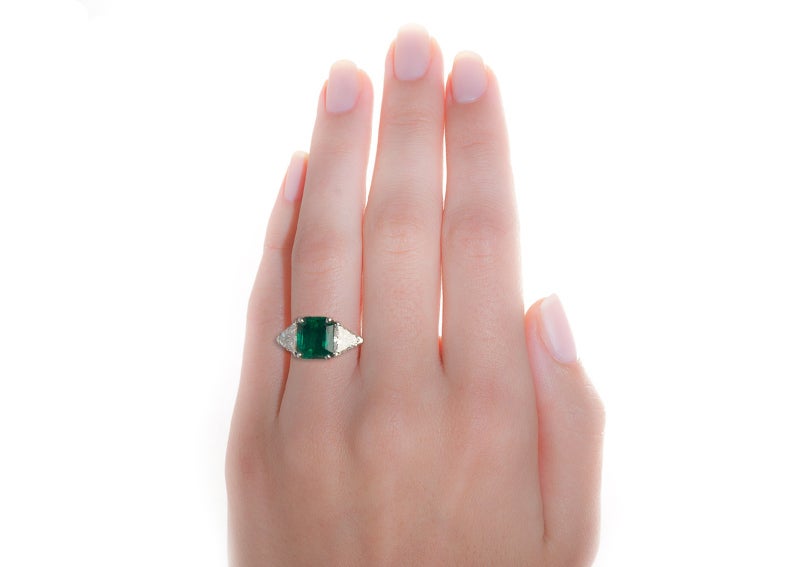 Adairsville is a 1960's Oscar Heyman ring made from platinum featuring a GIA certified octagonal step cut emerald. This beautiful emerald is flanked by two trillion cut diamonds. The ring has been documented by Oscar Heyman to be from 1966.