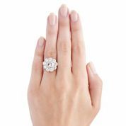 East Haven is a spectacular Edwardian style diamond cluster ring featuring a 1.00ct EGL certified Round Brilliant cut diamond with H color and SI2 clarity. The gleaming center diamond is nestled in a milgrain bezel setting encircled by similarly set