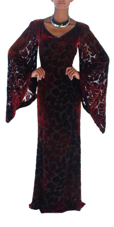 Born in North Africa, Yves Saint Laurent was incredibly inspired by the region's folk clothing.  Here we have a very elegant Djellaba in luxurious cut velvet of burgundy leaves on a black chiffon base.  The gown appears to be sheer but is lined in