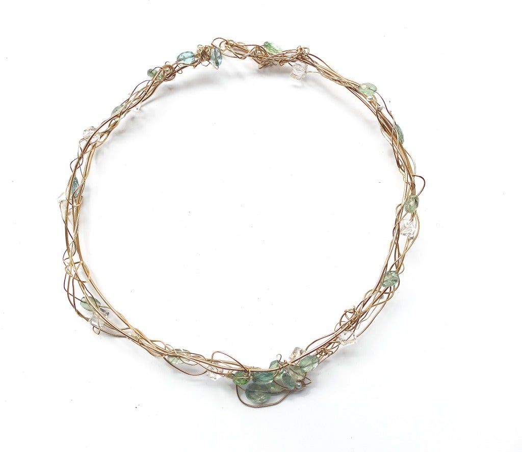 A beautiful Kazuko One of One choker.

Kazuko was a jeweler and artist who sold her work exclusively at Barneys New York from 1986 until her death in 2007.  She is well known for her beautifully wrapped web of gold wrapped crystals and semi