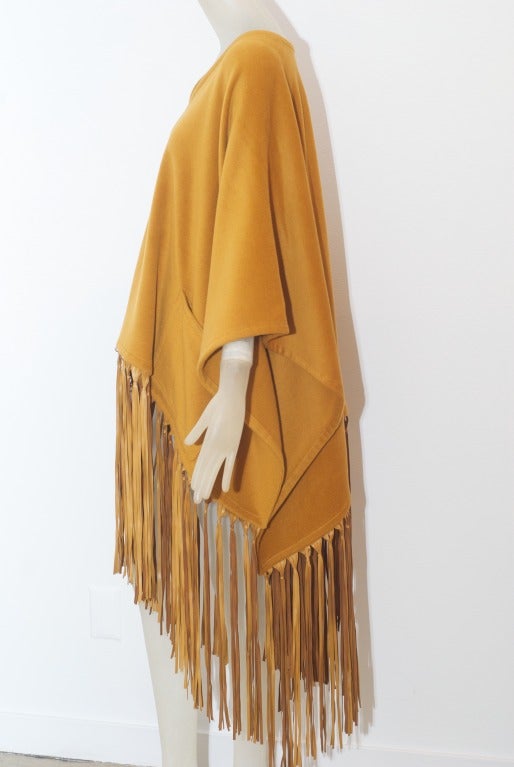 A wonderful curry colored cashmere and leather fringed luxe poncho beautifully made by Hermes.