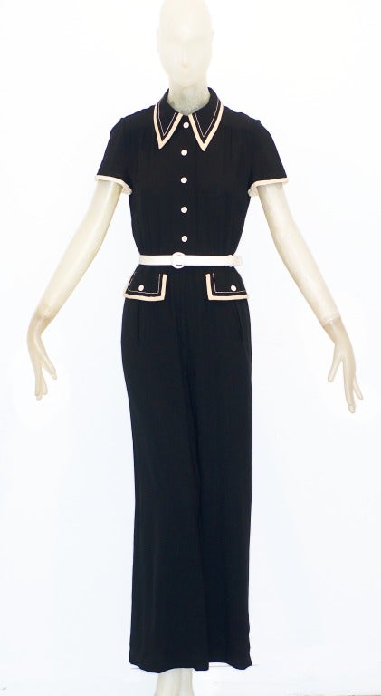 A sweetly wonderful sailor inspired jumpsuit by the great American couturier, James Galanos (1924 - ).  Black and cream Galanos jumpsuit, fitted in the waist and hips gently falling to a wide leg.

Mr. Galanos who worked and continues to live in
