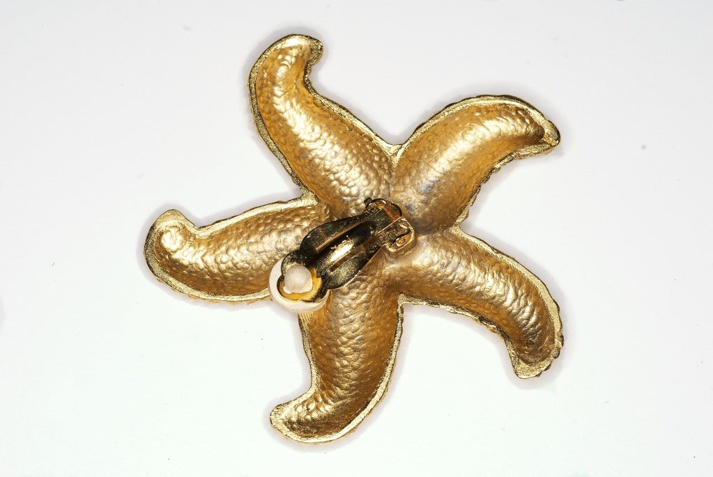 Yves Saint Laurent mottled gilt starfish earrings.  Circa 1990s.  Please note these are unsigned.

Earrings measure 2 1/2 by 2 1/2 inches.