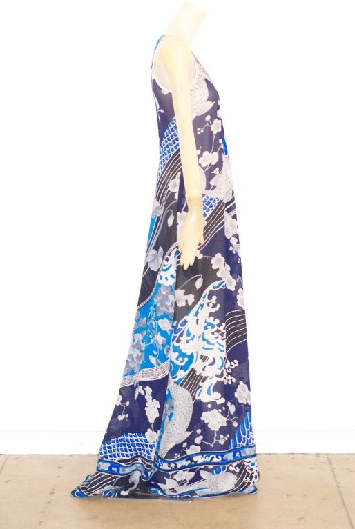A beautiful long haute bohemian gown in a  Mediterranean blue with a Japanese print of koi.  Silver cloth smoching at top of dress.  Dress is slightly sheer.