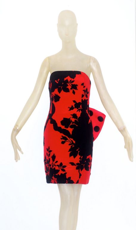 Wonderful and whimsical Christian Dior haute couture cocktail dress.  The dress is a beautiful strapless sheath in the front but the back is an ebullient mix of silk organza polka dots and a red and black oversized flower.  A very beautiful and very