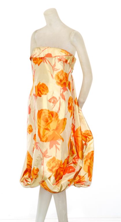 Striking and beautiful apricot silk chiné strapless cocktail dress with an extravagant sweep of fabric into a bubble back by the great Italian coutier Gandini.  The dress is chic and sexy draping itself around the body.  Dress has an interior cotton