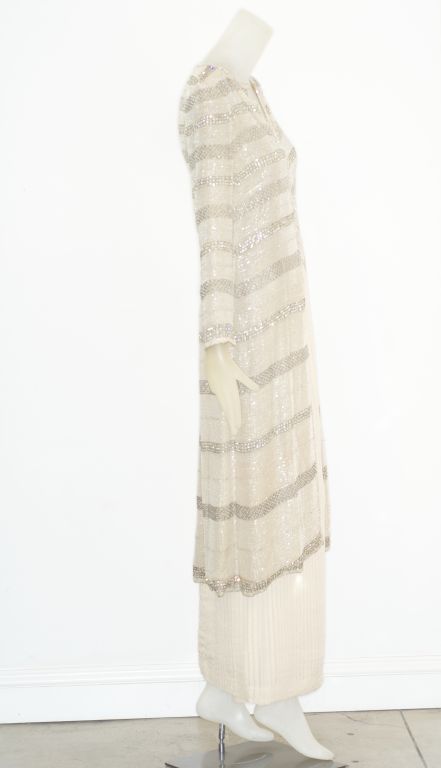 1977 Chanel haute couture runway ensemble.  The cardigan style jacket is fully beaded.  The skirt is finely pleated with tiny double pleats.  We have had this piece expertly cleaned at The French Hand Laundry and have left the pleats with the tiny