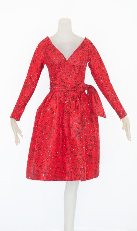 From the garde robe of a well known haute couture client.  Hubert de Givenchy haute couture cocktail dress in red silk embroidered all over with tiny seed pearls.  Bodice is fitted and the full skirt of the dress is lined in horsehair.  Dress is a