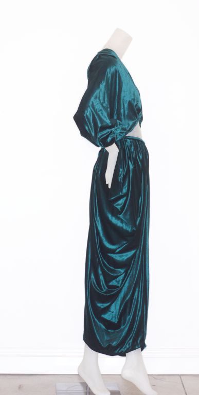 Early 1970s dramatic and gorgeous Norma Kamali green velvet ensemble.  Cropped top has kimono like sleeves.  Draped skirt has a slit in the back.  Label: Kamali<br />
<br />
RARE vintage <br />
STORE HOURS: Monday - Friday 11:30AM to 6PM<br