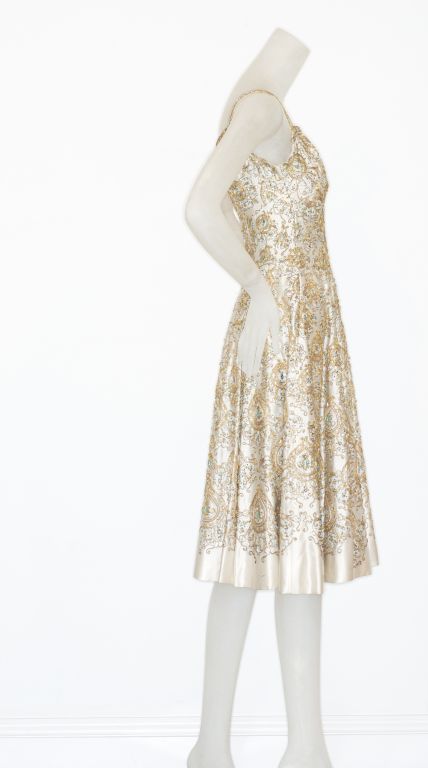 A finely Beaded 1950s Italian Silk Cocktail Dress<br />
<br />
This dress is very similar to a dress Audrey Hepburn wore to the Academy Awards in 1954.  She was 24 years old and she opted to wear a short ivory dress from Givenchy.  Her dress had