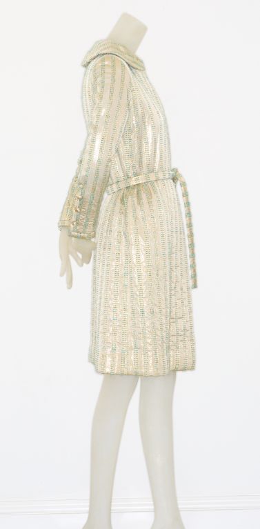 Attributed to Chanel haute couture from the late 1970s is this beautiful gold lamé wrap coat flecked with turquoise.<br />
<br />
Unlabeled runway piece with original mannequin label.<br />
<br />
Fits a modern size 4/6<br />
<br />
RARE