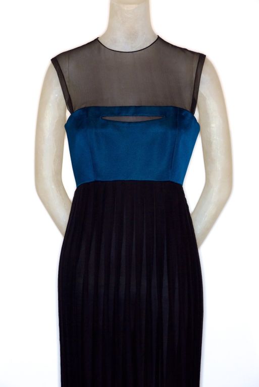 A Geoffrey Beene gown in azure blue silk and black pleated silk chiffon.  Mr. Beene brilliantly  created a slash at the top of the bodice so the overall look is light, beautiful and modern.  Fits a size 6.<br />
<br />
RARE vintage <br />
STORE