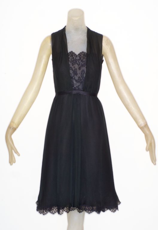 A beautiful Chanel little black dress in chiffon and lace with black on black jeweled buttons running down the back and a silk ribbon belt.<br />
<br />
RARE vintage<br />
STORE HOURS: Monday to Friday 11:30 to 6PM<br />
Weekends by appointment.