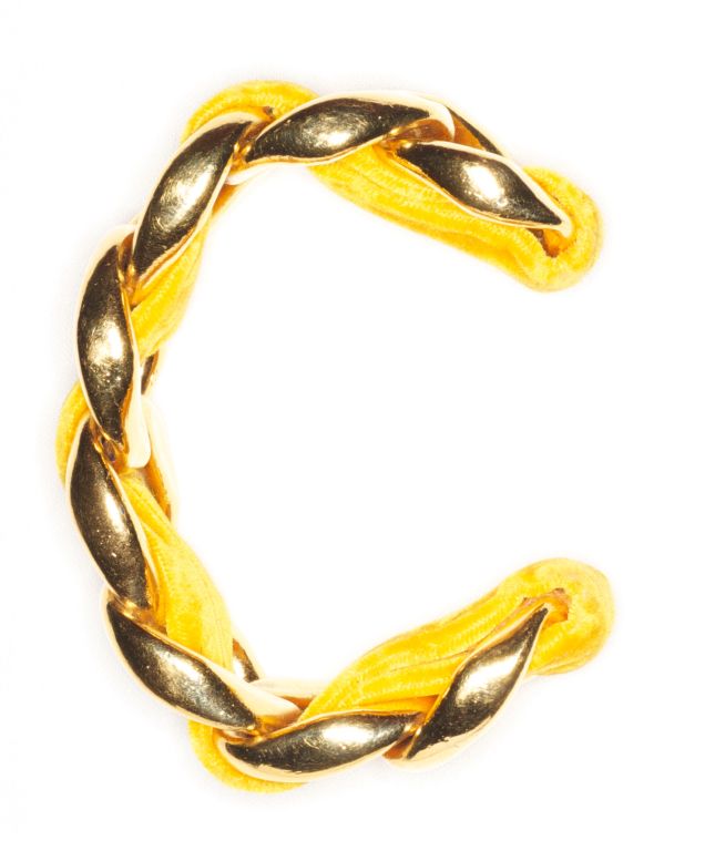 A gorgeous Chanel chain cuff woven with an antique silk ribbon in an eye popping daffodil yellow.<br />
<br />
RARE vintage<br />
STORE HOURS: Monday to Friday 11:30 to 6PM<br />
24 West 57th Street<br />
Fifth floor<br />
in The New York