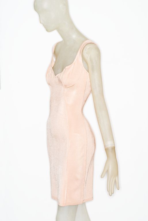 Tunisian-born designer Azzedine Alaia , a master of cut and form, redefined dressing in the 1980s with his shapely knit dresses seamed and bolded to the body.  This dress in a pale powdery pink is classic Alaia tight-to-the-body and beautifully