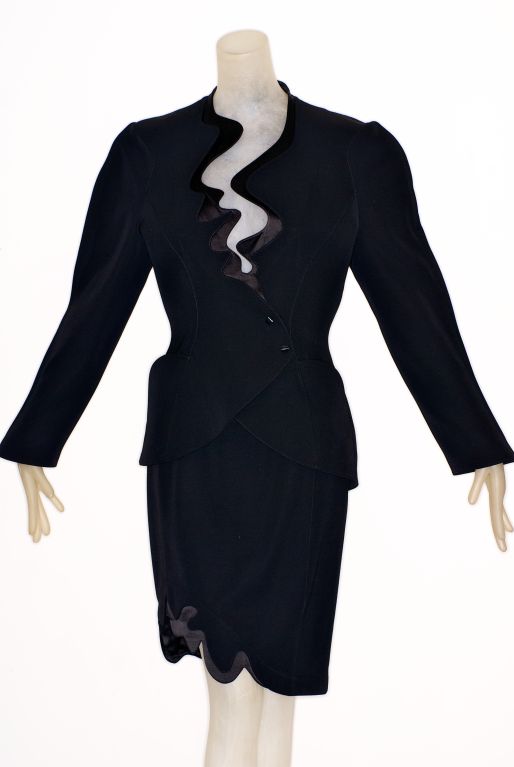 Thierry Mugler created the futuristic power babe with his sharply tailored, wildly imaginative suits in the 1980s.<br />
<br />
This exceptional suit is in a thin lightweight wool with wave detail in silk.  A similar version is in the collection