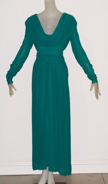 Beautiful Yves Saint Laurent rive gauche teal colored silk gown with a draped neckline.  Bodice is discreetly sheer as are the arms.  A classic and timeless design by YSL.  Fits a contemporary size 6.<br />
<br />
RARE vintage<br />
STORE HOURS: