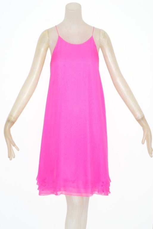 Neon pink Halston silk chiffon dress.  Dress is in four layers of chiffon and simply slips over chemise style.<br />
<br />
RARE vintage<br />
STORE HOURS: Monday to Friday 11:30 to 6PM<br />
24 West 57th Street<br />
212.581.7273<br />
Fifth