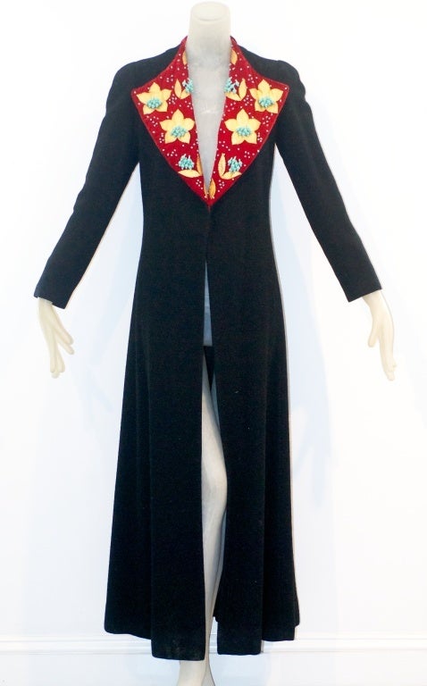 Extraordinary House of Schiaparelli 1936 evening coat in black chinchilla cloth with a wine-red collar appliquéd with gold leather and turquoise beads.    The embroidered gold leather flowers are finely hand sewn.   The coat is beautifully cut,