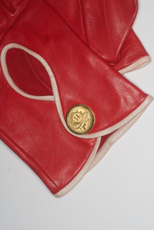 Hermes cherry red lambskin leather driving gloves.  Size 7. Buttery soft leather.  Fitted with a shorter length make them super chic.  Embellished with gold tone 'H' snap.  Excellent condition.  Labeled Hermes on the interior.