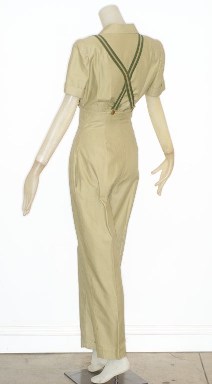 Military inspired 1970s Norma Kamali muted khaki green ensemble.  

*High waisted cotton garbadine pants.
*Pants front zip
*Original suspenders
*Defined shoulders top tucks into pants
*Shirt zips up
*Size 4
*1970s
*Made in the USA

RARE
