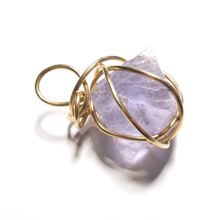 Kazuko gold wrapped amethyst pendant charm.


Kazuko Oshima was a Japanese born artist and jeweler who was known by one name, Kazuko. Her jewelry was sold exclusively at Barneys in New York until she passed away in 2007 and was collected by