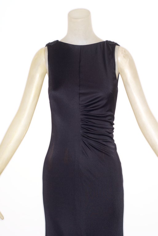 1990s slinky and sexy Gianni Versace couture black jersey gown, draped and gathered,  with beading at shoulders.  Dress is cut close to the body and slit up the front.  Will fit a contemporary size 4.
