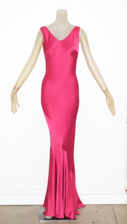 John Galliano has taken inspiration from many historical periods and this berry pink hammered crepe gown was certainly inspired by the glamorous and body conscious, bias cut evening gowns worn by 1930s movie stars.  The gown is beautifully cut and