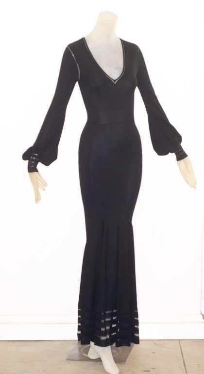 Alenxander McQueen black knit dress cut very close to the body.