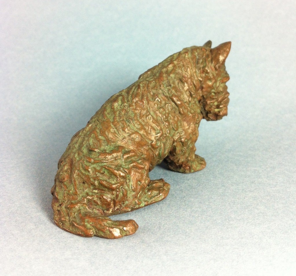Bronze Scottish Terrier with greenish-brown patina.
One of a series of small dog bronzes made by the Gorham & Co. Foundry. One of 30. 
Stamped Gorham & Co. ?© M Kirmse?.
These rare little bronze dogs were commissioned by Gorham & Co in the 1930?s
