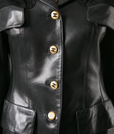 Gorgeous Black leather jacket from Chanel featuring a spread collar, notched lapels, quilted suede panels at the shoulders, four front flap pockets, a gold-tone logo front button fastening and long sleeves. Excellent vintage condition. Size: 40.